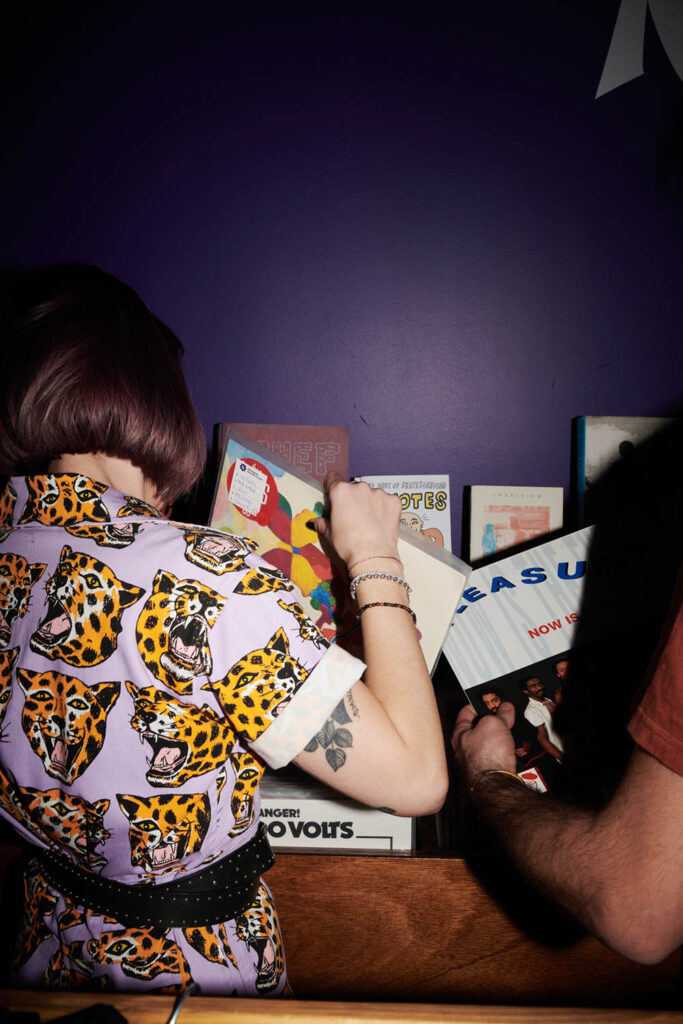 Girl looking vinyls at Reverend record store & cocktail bar
