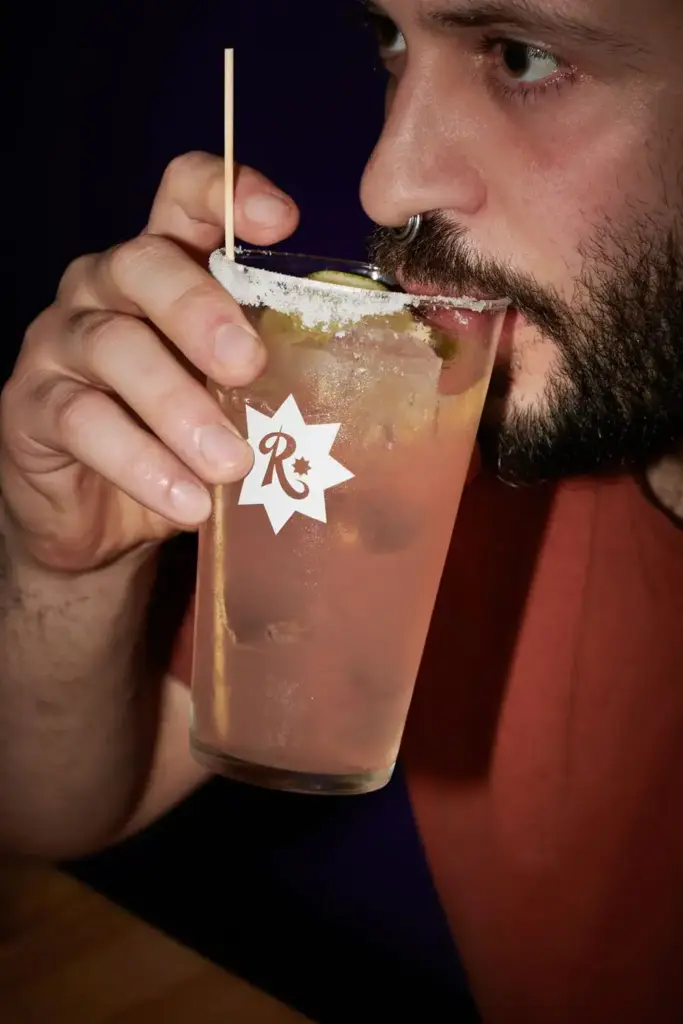 Man drinking a cocktail